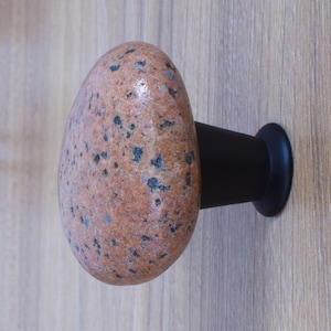 Elegant stone furniture handles for cabinets, closets, and dressers – These handcrafted sea stone knobs provide a natural upgrade to kitchen cabinetry, dresser drawers, armoire doors, and office furniture. Designed with real beach pebbles and a sleek black metal base, they offer an organic yet sophisticated accent for home furnishings. Whether you're restoring vintage furniture or modernizing a space, these durable, stylish drawer pulls bring a touch of nature into any room.