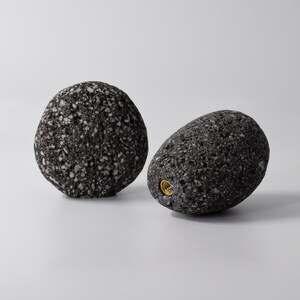 A variety of natural stone hooks in brown, grey, and white colors laid out on a wooden surface, showcasing their smooth round shape and brass fittings. Each hook is designed for easy mounting on walls, cabinets, or doors, adding a natural, earthy touch to your living space while providing durable and practical functionality