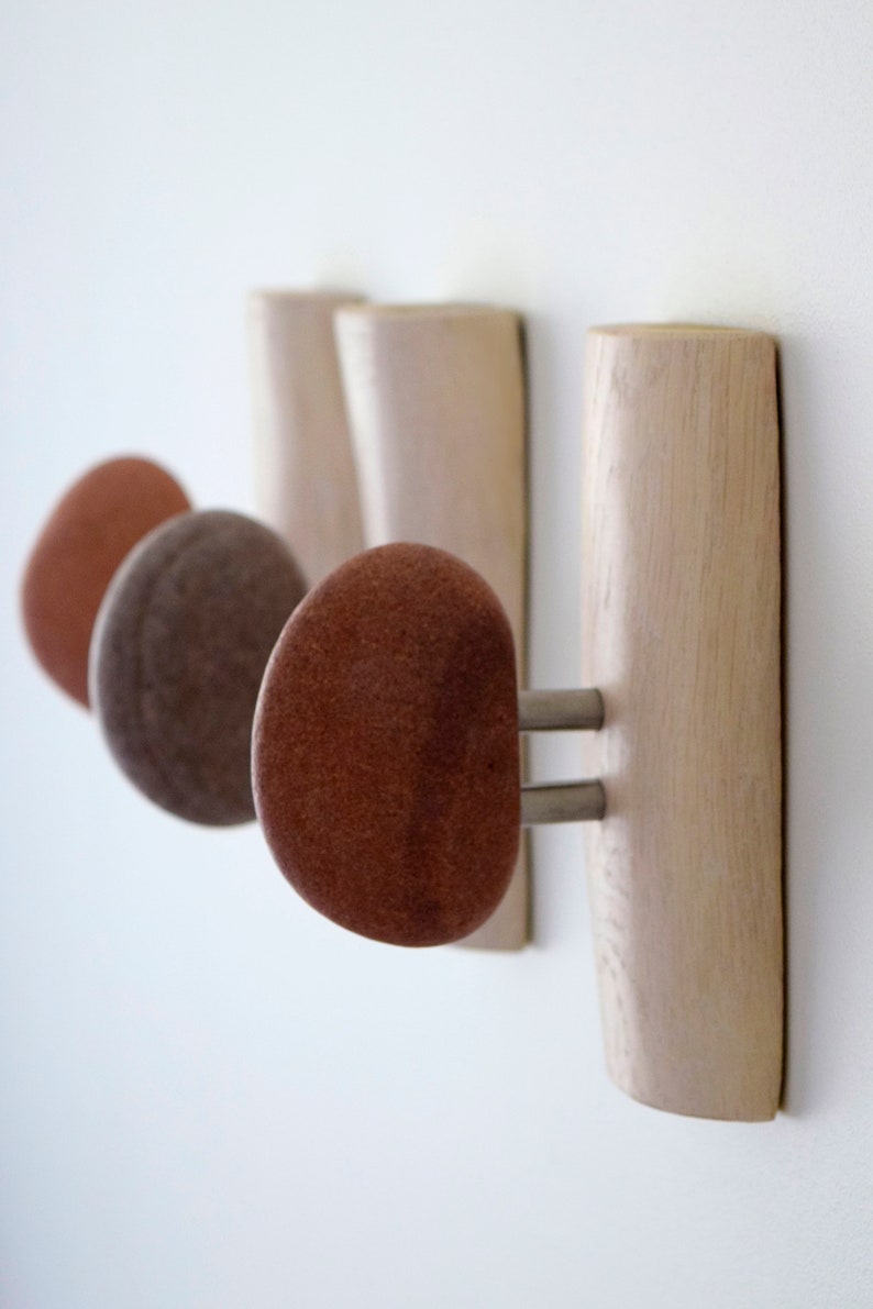 Sea stone robe door hangers, robe and towel hooks, wood robe hook. Outdoor robe hooks with smooth stones. Bathroom hooks and robe hangers with beach stone. Wall coat racks with shelf metal coat rack for wall. Wall mounted stone coat racks.