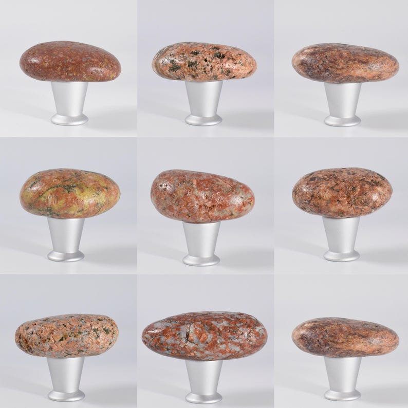 Natural rock cabinet knobs for kitchen, storage units, and furniture – Featuring real sea stones attached to a black metal base, these unique drawer pulls enhance a variety of furniture pieces, including kitchen cabinets, wooden chests, bedside tables, and media consoles. Their smooth, rounded shape ensures a comfortable grip, while their earthy aesthetic makes them ideal for coastal, industrial, and rustic decor. Each stone varies in shape, making every handle one of a kind.