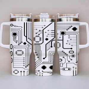 May include: Three white stainless steel travel mugs with black circuit board designs. The mugs have a handle on one side and a lid on top.