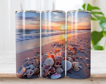 May include: Three stainless steel tumblers with a beach sunset and seashells design. The tumblers are on a wooden surface.
