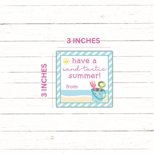 May include: A 3x3 inch blue and white striped tag with a yellow sun, pink text that says "have a sand-tastic summer!" and a bucket with beach toys. The tag says "from:" at the bottom.