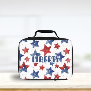 May include: A white lunch bag with a black handle and zipper. The bag has a red, white, and blue star pattern and the word "LIBERTY" printed in blue.