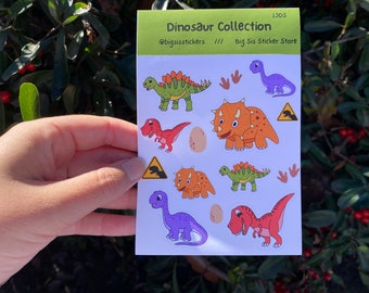 May include: A sheet of colorful dinosaur stickers with a variety of dinosaurs, including a stegosaurus, triceratops, and a T-Rex. The sheet is labeled "Dinosaur Collection" and "Big Sis Sticker Store".
