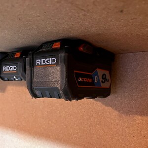 May include: Two black Ridgid batteries with orange buttons. The battery on the right is labeled "OCTANE" and "9Ah".