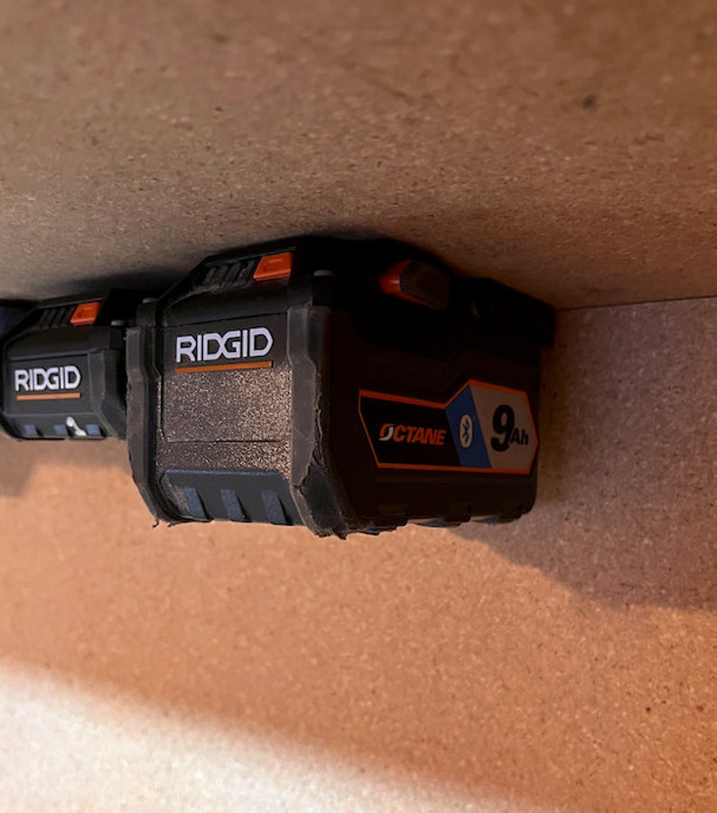May include: Two black Ridgid batteries with orange buttons. The battery on the right is labeled "OCTANE" and "9Ah".