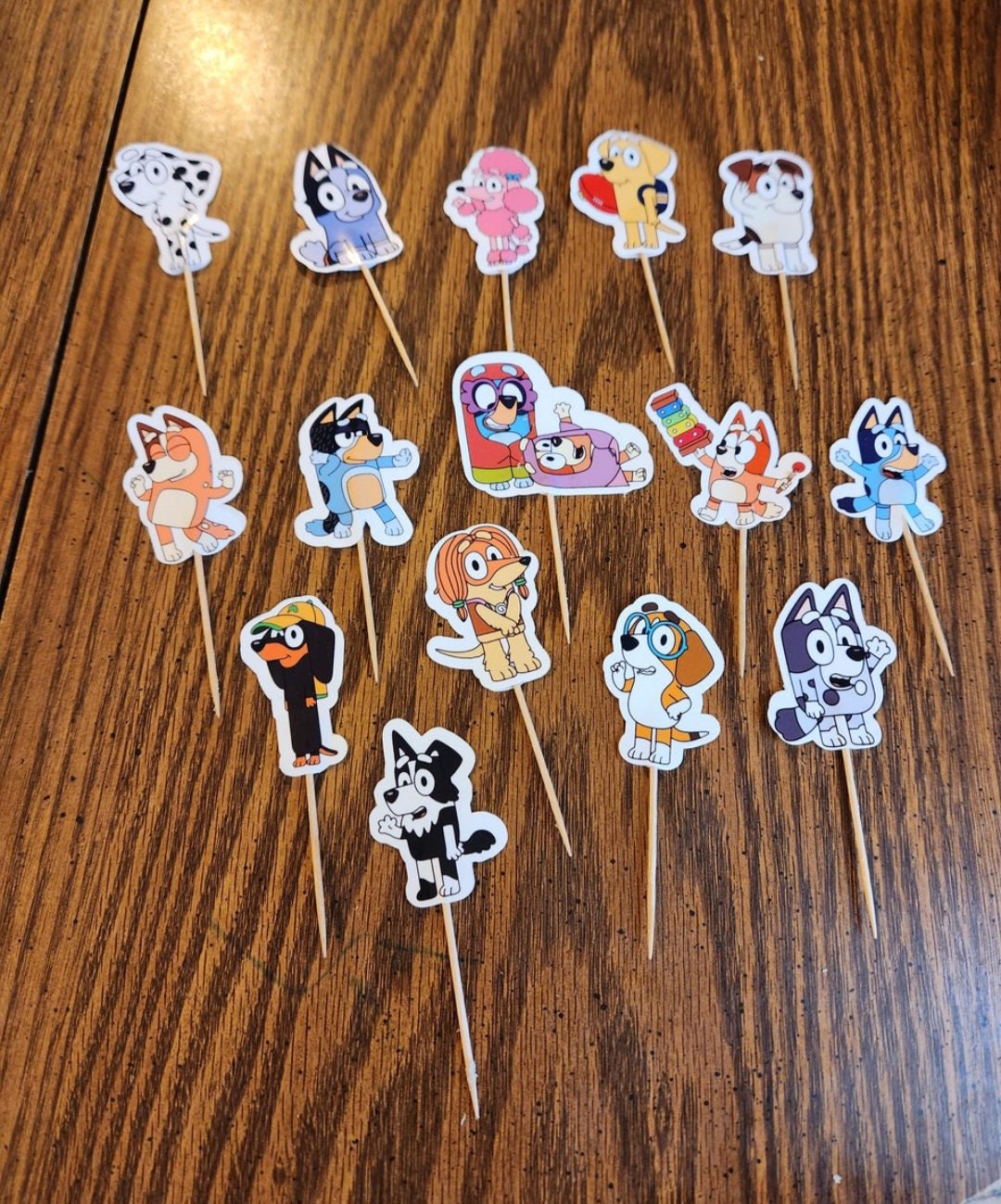 2. Bluey Cupcake Toppers- double sided.Comes in set of 15, 30 or 45 cupcake toppers.They are 2 inches tall each width varies by design. Processing time: 2-3 days**Delivery time: can take up to two weeks, make sure to order early for your event!!** Orders for 15 do not come with tracking, however orders of 30 and 45 do have tracking.If you want to purchase additional tracking info I have a separate listing for that in my shop!Feel free to message me with any questions or requests!! :)