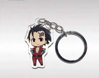 May include: An acrylic keychain featuring a chibi-style character with spiky black hair, a spiral mark on the forehead, and a red outfit with silver arm guards. The character is attached to a silver metal split ring by a short chain link.