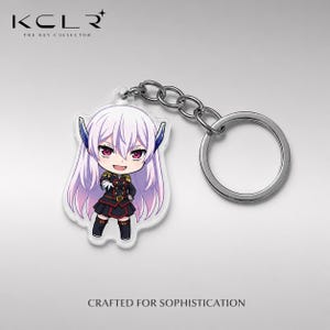 May include: An acrylic keychain featuring a chibi-style anime character with long light purple hair, red eyes, and a dark military-inspired uniform with gold accents. The character is attached to a silver-toned metal split ring by a short chain.