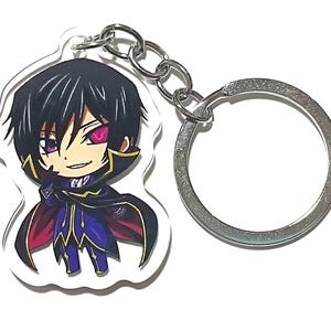 May include: A clear acrylic keychain featuring a chibi-style anime character with black hair and purple eyes. The character wears a dark cape and blue outfit. The keychain has a silver keyring and chain.