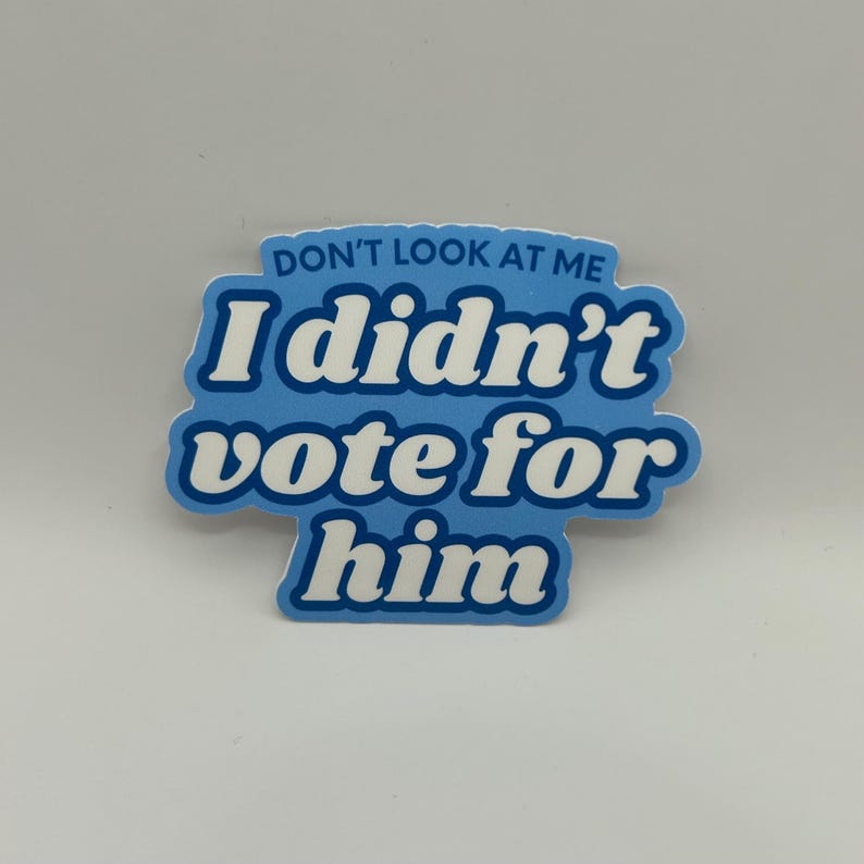 May include: A blue sticker with white text that reads "Don't look at me I didn't vote for him".
