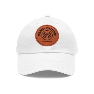 May include: White baseball cap with a brown leather patch that says "Camp Chump Jeff Lewis Live" in black text.