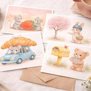 May include: Watercolor greeting cards featuring whimsical illustrations. One card shows two mice with a strawberry, another a mouse driving a car with a croissant, a bunny with a bag, and a teddy bear with a package.