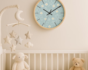 May include: A light blue baby nursery clock with a white honeycomb and daisy pattern. The clock has black hands and a wooden frame.