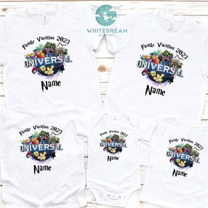 May include: White t-shirts with a graphic of the Universal Studios logo and the text "Family Vacation 2023" and "Name". The shirts are in different sizes for adults and children.