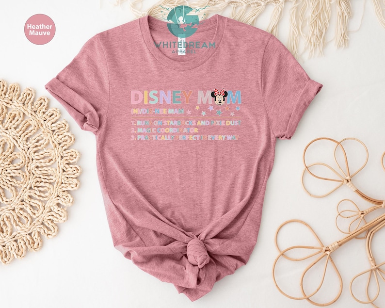 May include: A heather mauve t-shirt with the text "DISNEY MOM (NUDGE ME MAN) 1. RUN ON STARBUCKS AND PIXIE DUST 2. MAGIC COORDINATOR 3. PRACTICALLY PERFECT EVERY WAY" and a cartoon image of Minnie Mouse.