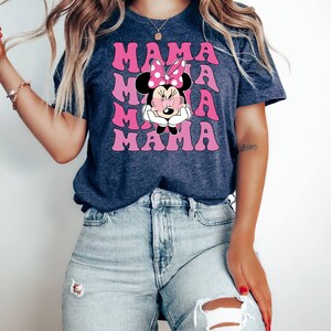May include: A navy blue t-shirt with a pink and white graphic of Minnie Mouse with the word "MAMA" repeated in pink letters.