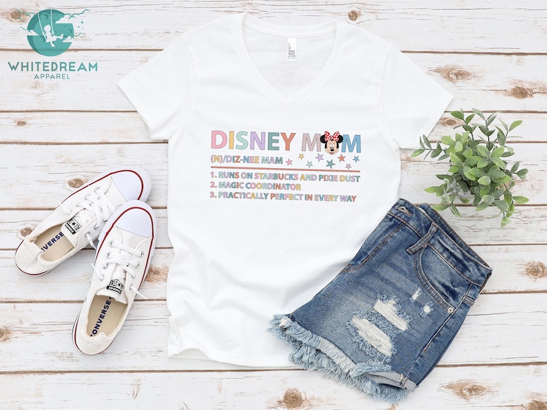 May include: White v-neck t-shirt with the text "DISNEY MOM (N)/DIZ-NEI MAM" and a cartoon image of Minnie Mouse. The text below the title reads "1. Runs on Starbucks and Pixie Dust 2. Magic Coordinator 3. Practically Perfect in Every Way"