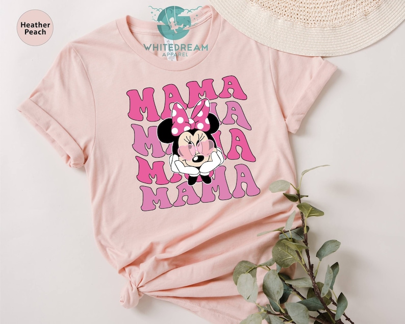 May include: Pink t-shirt with a pink and white graphic of Minnie Mouse with the word "MAMA" repeated four times in a retro font.