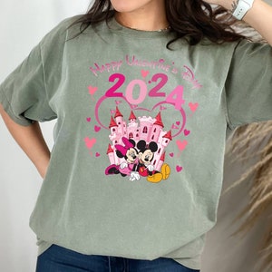 May include: Green t-shirt with a pink castle, Mickey Mouse and Minnie Mouse, and the text "Happy Valentine's Day 2024".