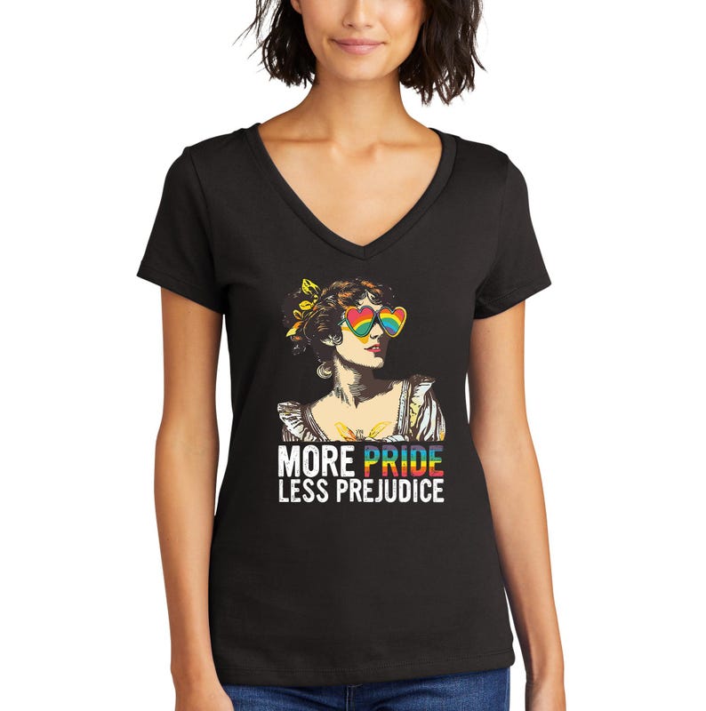 May include: Black v-neck t-shirt with a colorful illustration of a woman wearing rainbow heart-shaped sunglasses. The text "More Pride Less Prejudice" is printed below the illustration.