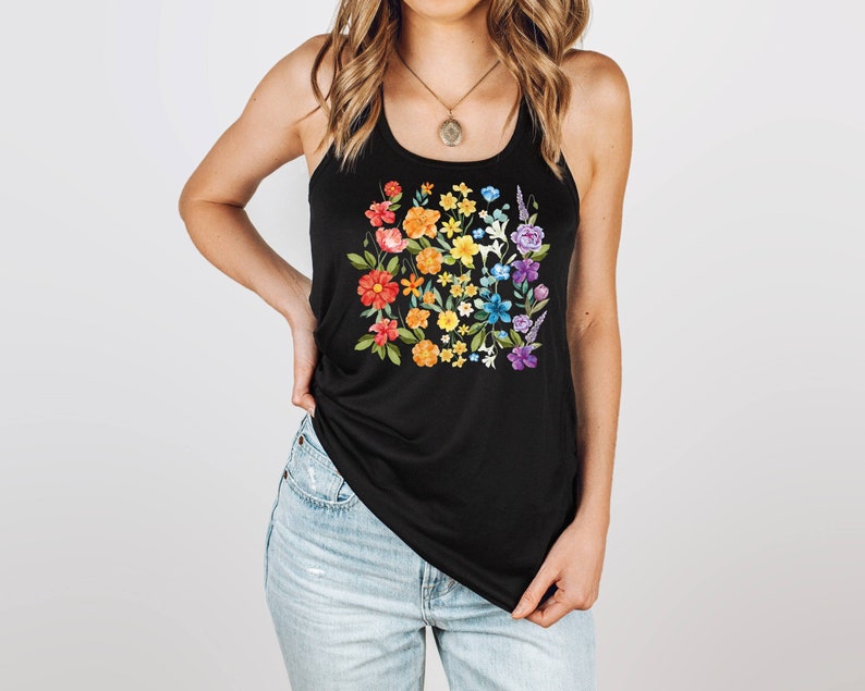 May include: A black tank top with a rainbow floral print. The flowers are arranged in a square shape and are in shades of red, orange, yellow, green, blue, and purple.