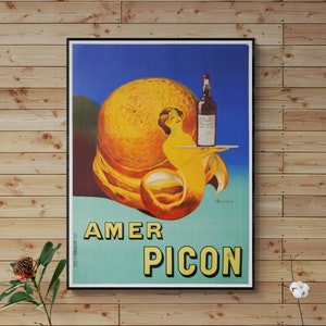 Peut inclure: Affiche vintage pour Amer Picon, une liqueur d'orange amère. L'affiche représente une femme tenant un plateau avec une bouteille d'Amer Picon et une tranche d'orange.