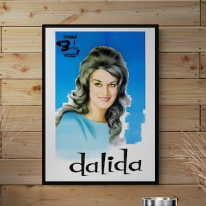 May include: A vintage poster featuring a black and white photo of singer Dalida. The poster has a blue background with the text "Vedette Barclay Disques" and "Dalida" in large black letters.