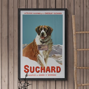May include: Vintage poster advertising Swiss chocolate brand Suchard. The poster features a Saint Bernard dog standing in a snowy mountain landscape. The text on the poster reads "La Suisse Illustree par le Chocolat Suchard" and "Suchard Hospice du Grand St Bernard".