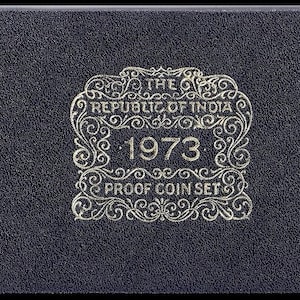 May include: A black leather box with gold lettering that reads "The Republic of India 1973 Proof Coin Set".