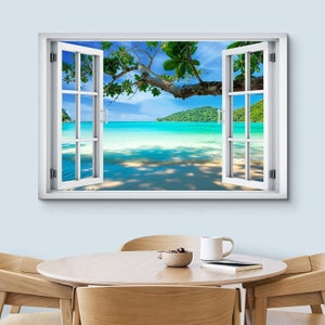 May include: A white window frame with a view of a tropical beach. The window is open and the beach is visible through the opening. The beach is sandy with clear blue water and lush green trees in the background.