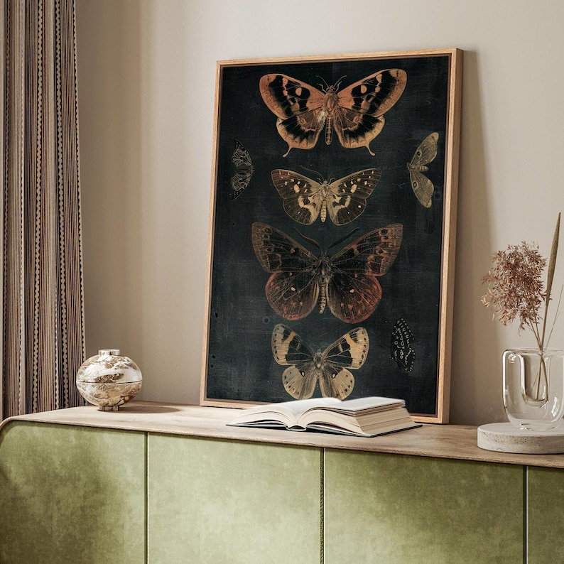 May include: A framed print of five butterflies on a dark background. The butterflies are in various shades of brown, orange, and yellow. The print is framed in a simple wooden frame.