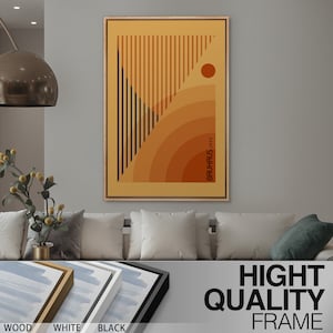 May include: A rectangular wall art print in a wooden frame featuring a geometric design with vertical black lines, concentric orange and brown semicircles, and a solid orange circle. The text BAUHAUS 1923 is printed vertically in black.