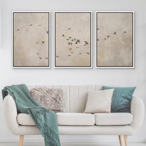 May include: Three framed prints with a beige background and a flock of birds flying in formation. The prints are arranged in a row, with the leftmost print showing the birds in the lower left corner, the middle print showing the birds in the center, and the rightmost print showing the birds in the upper right corner.