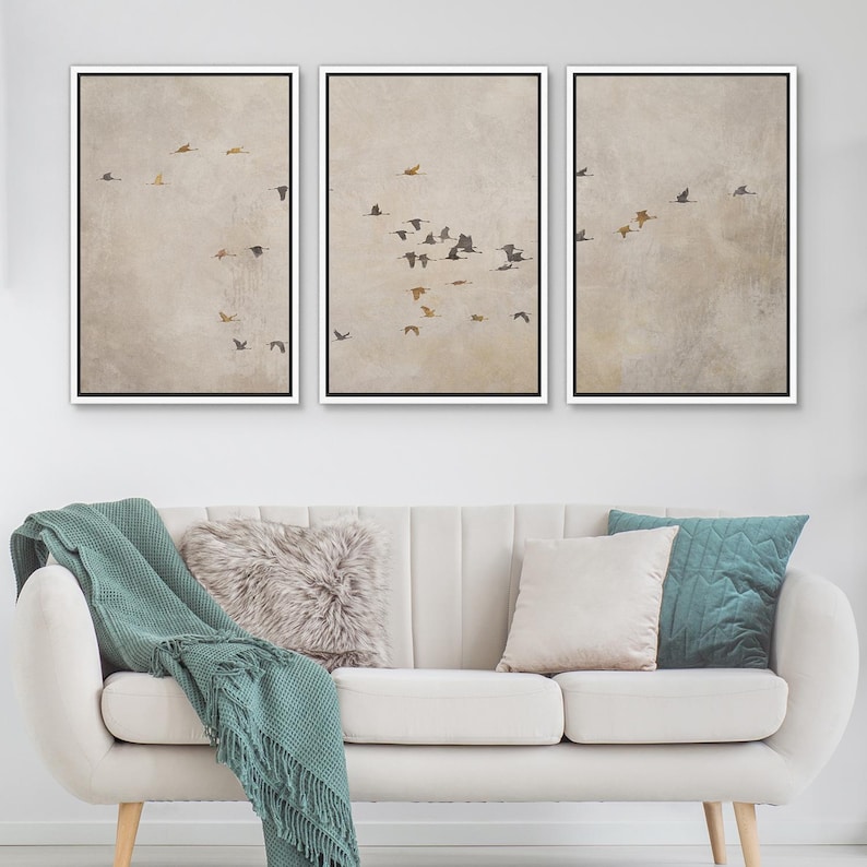 May include: Three framed prints with a beige background and a flock of birds flying in formation. The prints are arranged in a row, with the leftmost print showing the birds in the lower left corner, the middle print showing the birds in the center, and the rightmost print showing the birds in the upper right corner.