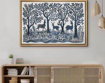 May include: A framed blue and white print of a forest scene with three deer. The deer are silhouetted against a background of trees and foliage.
