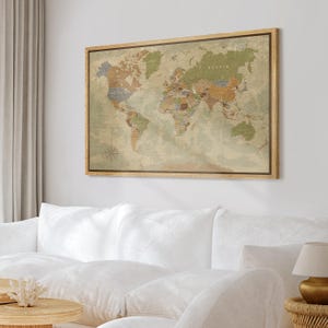 May include: A framed world map with a vintage aesthetic. The map features a detailed depiction of continents and countries in muted tones of green, brown, and beige. The wooden frame adds a classic touch to the artwork, suitable for home decor.