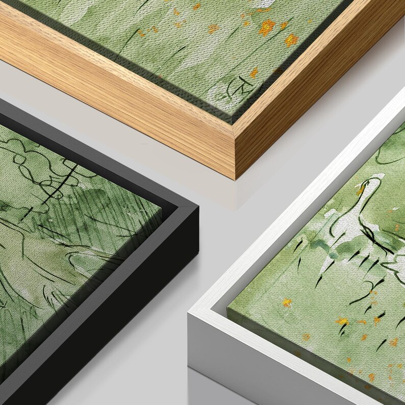 May include: Close-up of three framed canvas art pieces. The artwork features green and white watercolor-style paintings with black line drawings. The frames are in natural wood, black, and white.