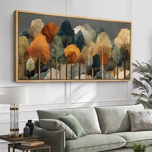 May include: A rectangular wall art piece featuring a stylized forest landscape with layered trees in shades of orange, gold, dark green, and cream. The artwork is enclosed in a thin, light-toned wooden frame, showcasing a dense woodland scene.