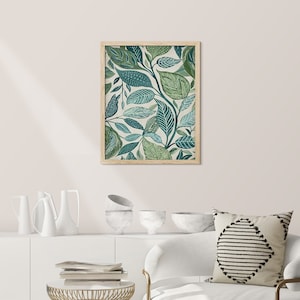 May include: A framed print with a botanical design featuring green and blue leaves on a cream background.