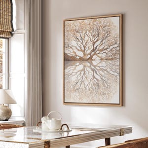 May include: A framed watercolor painting of a tree with its reflection. The artwork features a symmetrical design with a light brown color palette. The painting is displayed on a white wall in a well-lit room.