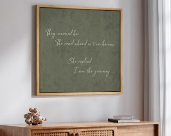 May include: A green framed canvas print with a white quote that reads "They warned her the road ahead is treacherous. She replied I am the journey."