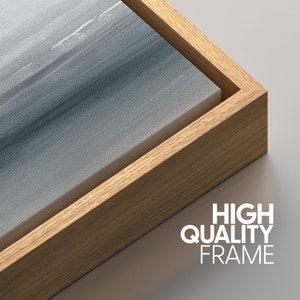 May include: Close-up of a wood frame around a canvas print. The wood frame is a light brown color. The text 'HIGH QUALITY FRAME' is printed in white below the frame.