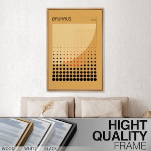 May include: A rectangular wall art print in a light wood frame featuring the text BAUHAUS and 1923. The graphic design displays a mustard yellow background with a grid of black and red dots, vertical lines, and a large semi-circular shape.