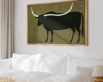 May include: A framed art print featuring a black bull silhouette with long, white horns against an olive green background. The artwork is encased in a natural wood frame, creating a rustic aesthetic. This piece is suitable for home decor.