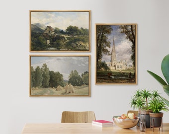 May include: Three framed landscape paintings with a rustic aesthetic. The paintings depict a bridge over a stream, a field of hay bales, and a cathedral in the distance.
