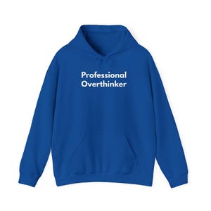 May include: A royal blue hoodie with a front pocket and a drawstring hood. The text "Professional Overthinker" is printed in white across the chest. The hoodie is made of a soft material.