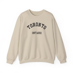 Toronto, Ontario (Unisex Heavy Blend Crewneck Sweatshirt) - simple black font, 6ix Layers, City of Neighbourhoods, Streetcar-Ready Style