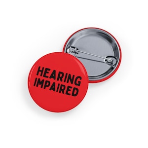 May include: Red button with the text "HEARING IMPAIRED" in black.